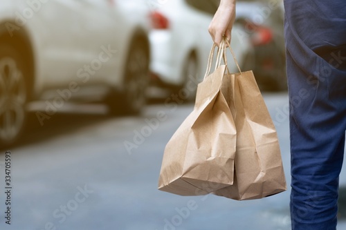 A woman order some food take home for eating in house during self quarantined, COVID-19 crisis