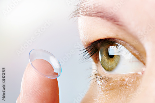 Foto Womans eye and contact lens