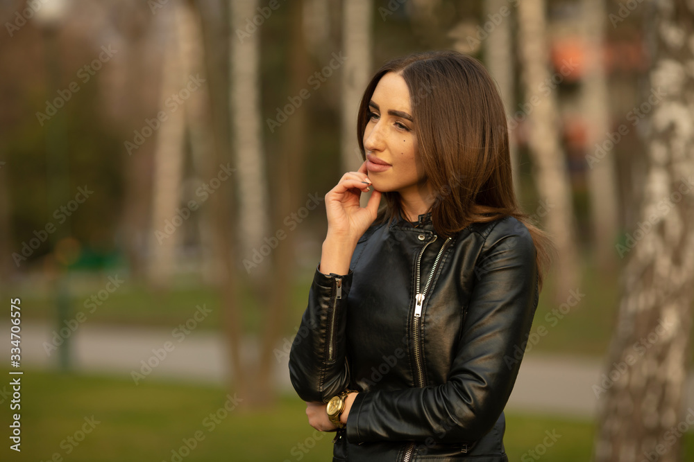 Portrait of beautiful young happy smiling woman, outdoors, with copy space.