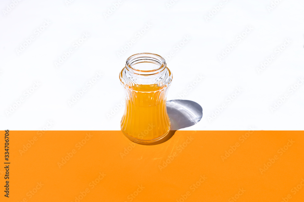 horizontal view glass with orange juice on white and orange background horizontal view glass with orange juice on white and orange background