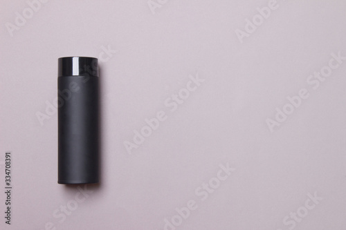 black thermos cup on grey background with copy space