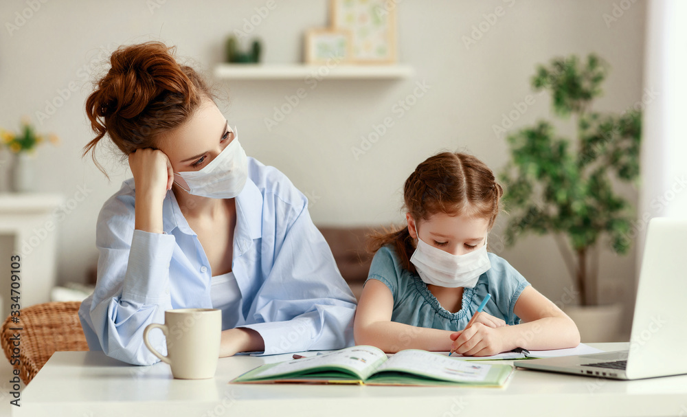 Tired mother watching daughter doing homework during quarantine Tired mother watching daughter doing homework during quarantine