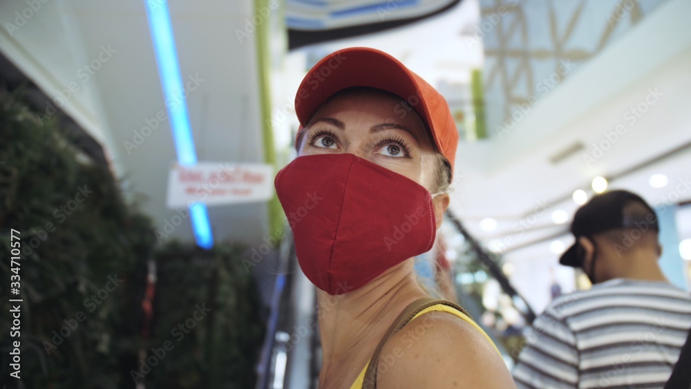 Woman travel caucasian visitor at a supermarket with wearing protective medical mask. Girl tourist customer a grocery store with protect respirator. Virus protection coronavirus pandemic covid-19. Woman travel caucasian visitor at a supermarket with wearing protective medical mask. Girl tourist customer a grocery store with protect respirator. Virus protection coronavirus pandemic covid-19.