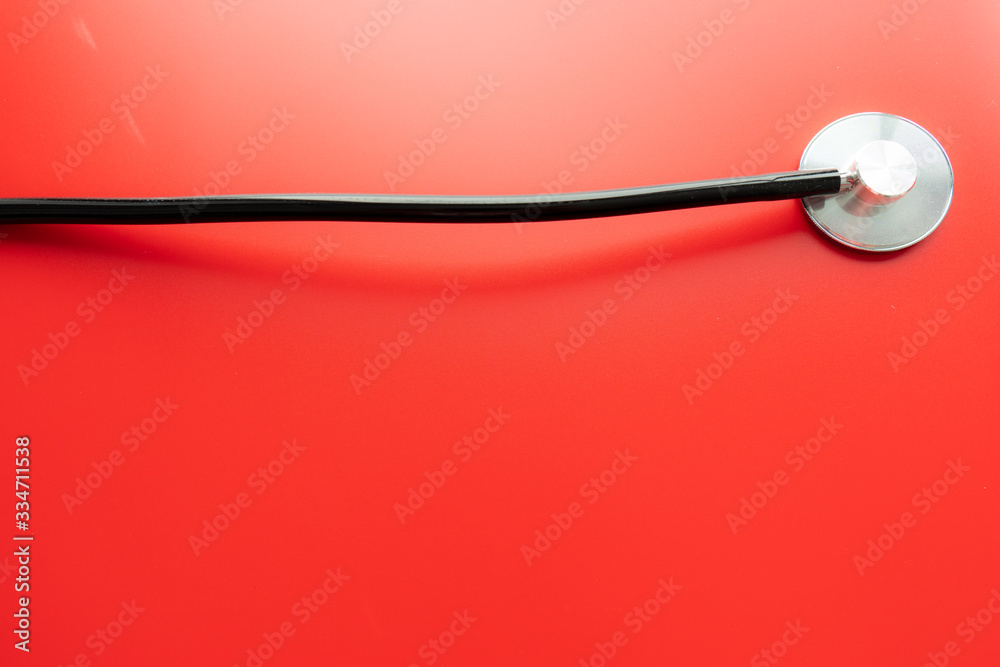 Close up of a stethoscope isolated on red background Close up of a stethoscope isolated on red background