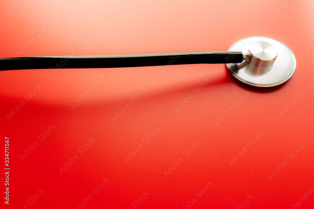 Close up of a stethoscope isolated on red background Close up of a stethoscope isolated on red background