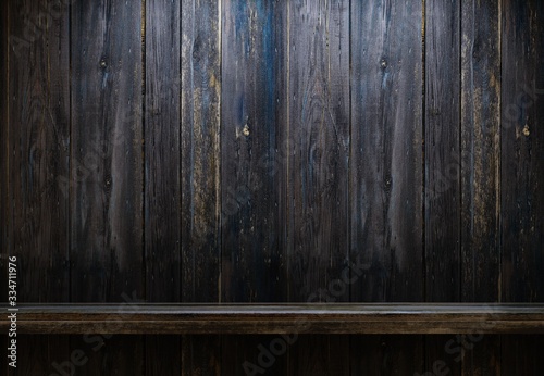 Empty wooden shelf in the night interior. A wooden old wall. Demonstration of objects. Interior of an old country house. 3D rendering.