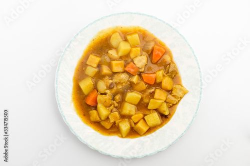 Curry with vegetables on white background