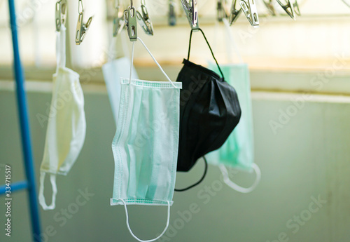 Disposable medical mask hanging on pegged clothesline for reused, Due to lack of disposable medical mask of novel coronavirus (COVID-19) situation in Thailand