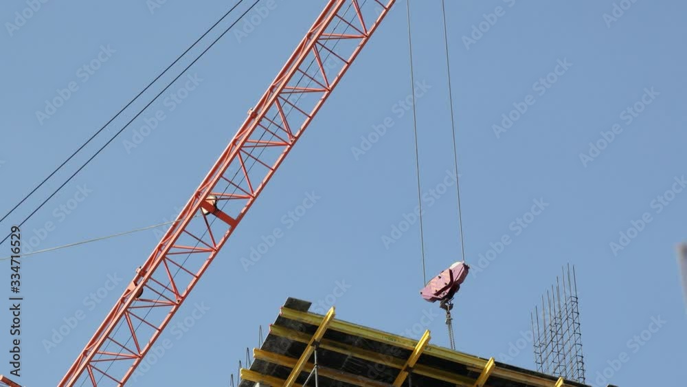 Construction cranes move building materials and work on the construction of multi-storey residential buildings Construction cranes move building materials and work on the construction of multi-storey residential buildings