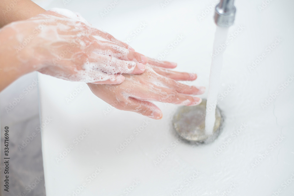 Fototapeta premium A woman is washing hands