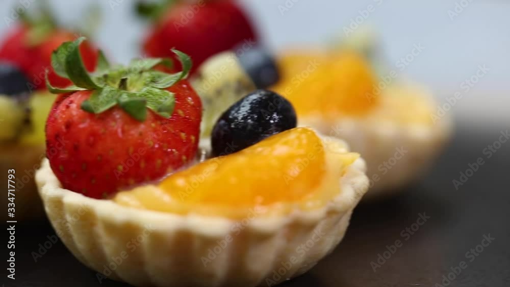 Still life photography of dessert : Fruits cake on table, fresh fruits around cake. Selective and shift focus and free space for text. Shooting in studio, Clean food good taste idea concept. Still life photography of dessert : Fruits cake on table, fresh fruits around cake. Selective and shift focus and free space for text. Shooting in studio, Clean food good taste idea concept.