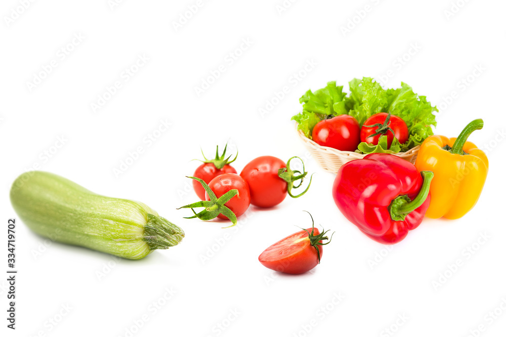 Ripe fresh organic vegetables in drops of dew isolated on a white background. Tomatoes, zucchini, bell peppers and lettuce isolated on a white background. Ripe fresh organic vegetables in drops of dew isolated on a white background. Tomatoes, zucchini, bell peppers and lettuce isolated on a white background.
