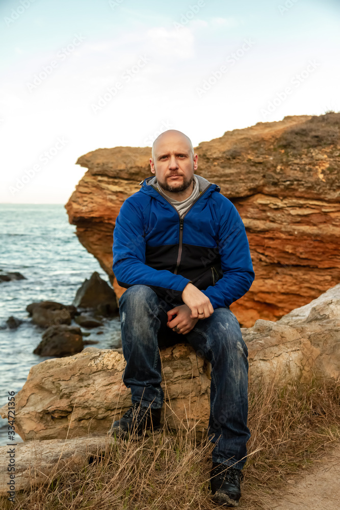Portrait of a bald man on the sea coast Portrait of a bald man on the sea coast
