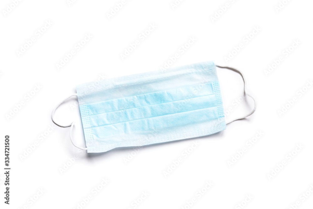 Blue disposable earloop face mask isolated on a white background. Coronavirus protection Blue disposable earloop face mask isolated on a white background. Coronavirus protection