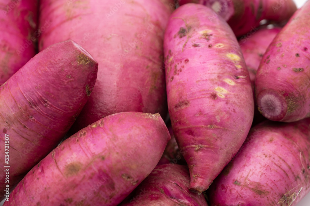 Pile of whole fresh raw purple daikon radish Pile of whole fresh raw purple daikon radish