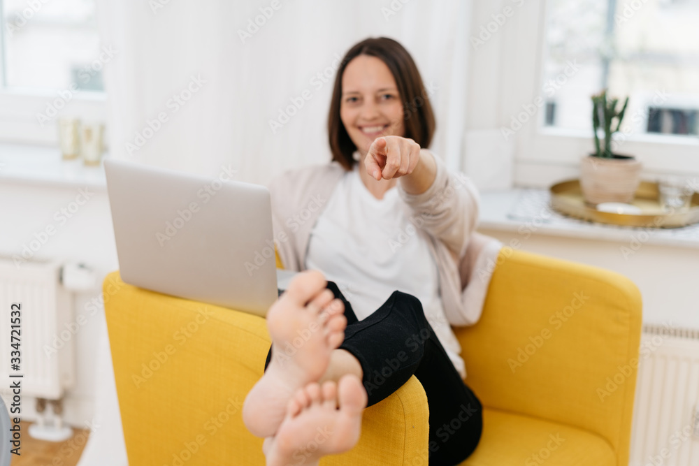 Smiling woman pointing at the camera