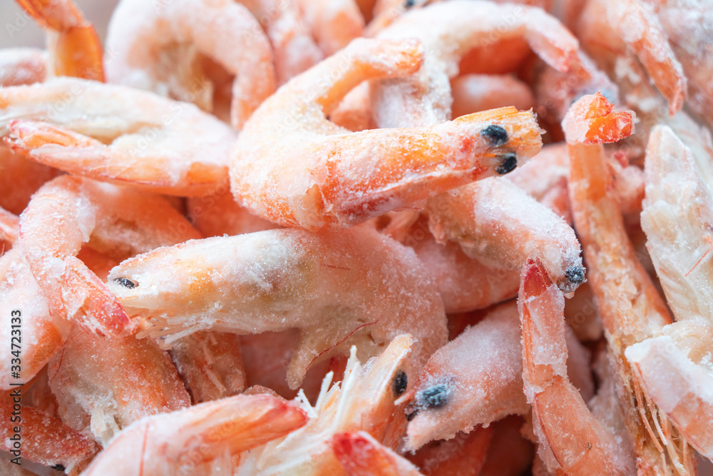 Frozen big shrimps close up. Raw frozen shrimp background. Pile of frozen shrimps background Frozen big shrimps close up. Raw frozen shrimp background. Pile of frozen shrimps background