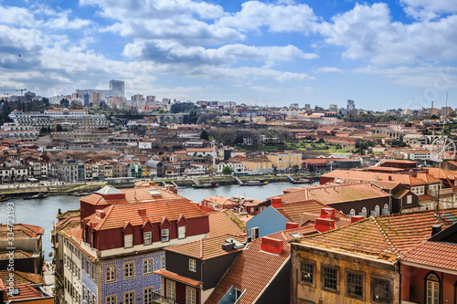 Sweeping view over the city of Porto, Portugal with the Douro River and characteristic terra-cotta rooftops. 