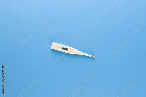 Clinical digital thermometer for checking body temperature isolated on light blue background