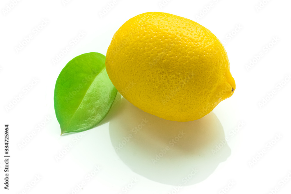 Lemon and green leaf isolated on white background
