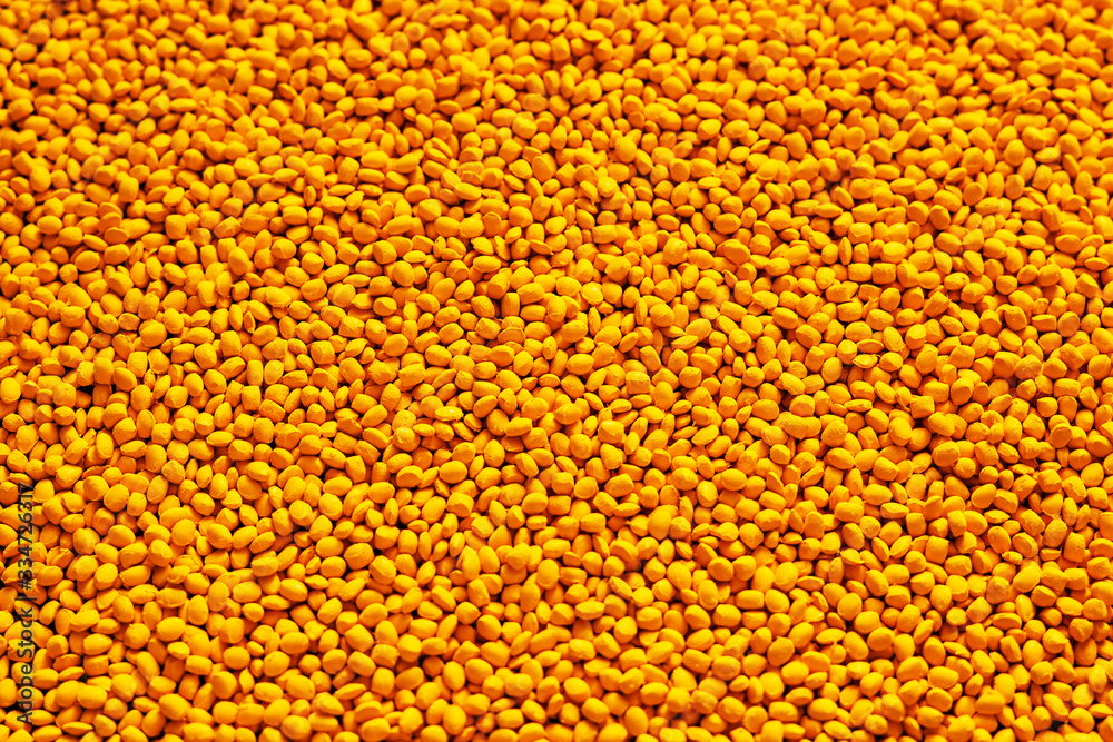 Yellow polymer dye in granules, background texture