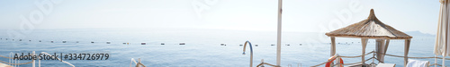 Sea ​​view from comfortable wooden pier. Ultra wide panorama shot