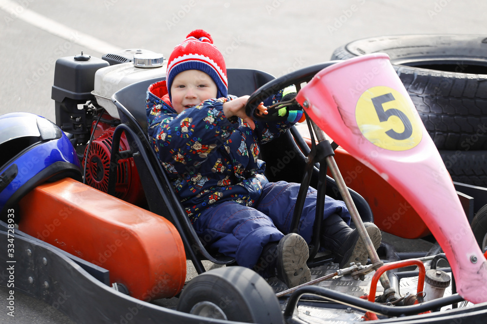 boy is driving Go-kart car with speed in a playground racing track. boy is driving Go-kart car with speed in a playground racing track.