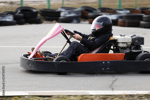 boy is driving Go-kart car with speed in a playground racing track. © makam1969