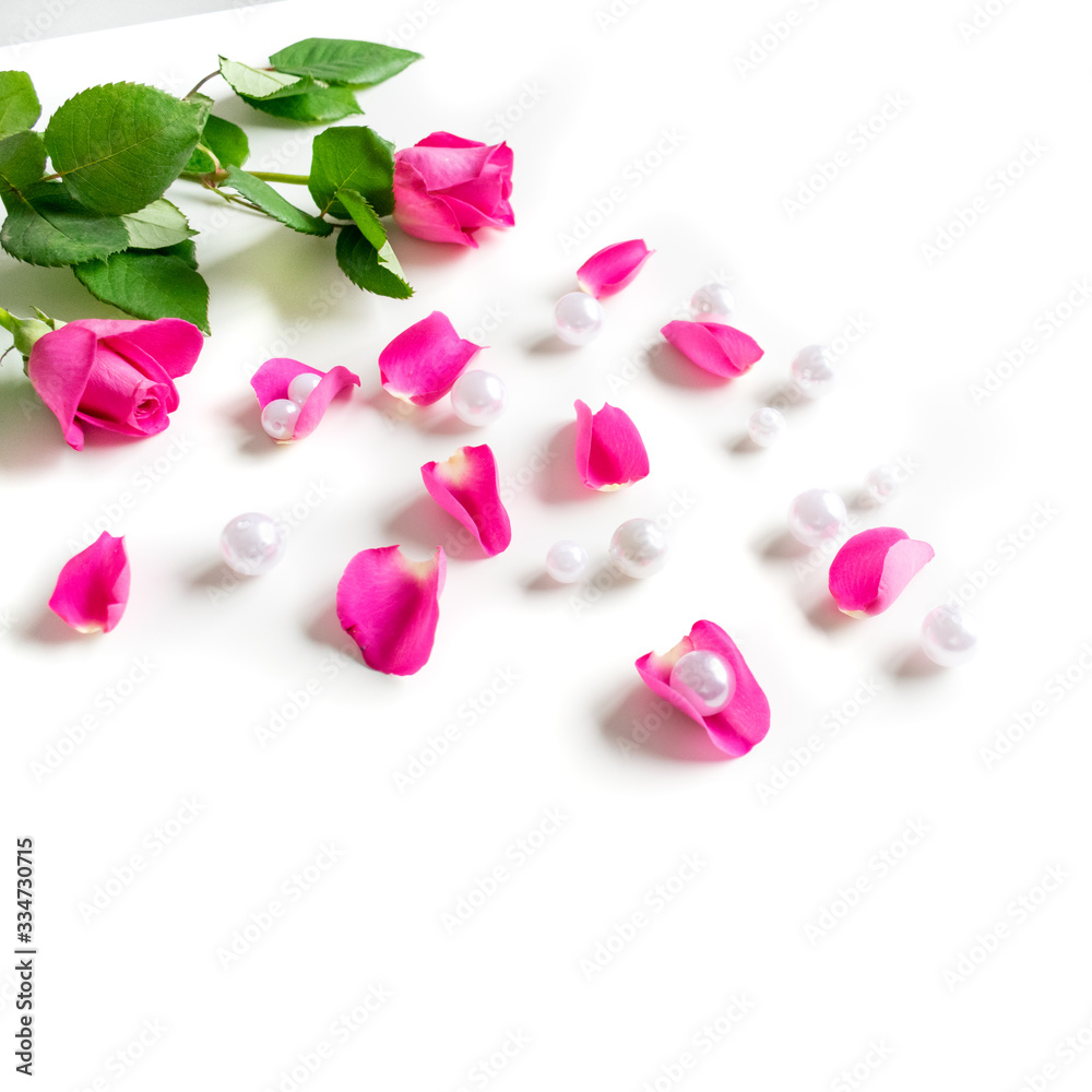 Pink Bible flat lay: Pearls, pink rose petals, open book and golden key on white bright background. Morning devotional with pink roses. Top view. Baselland, Switzerland - 22.11.2019
