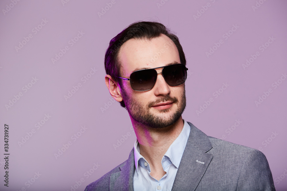 Studio portrait of handsome elegant young man in grey jacket Studio portrait of handsome elegant young man in grey jacket