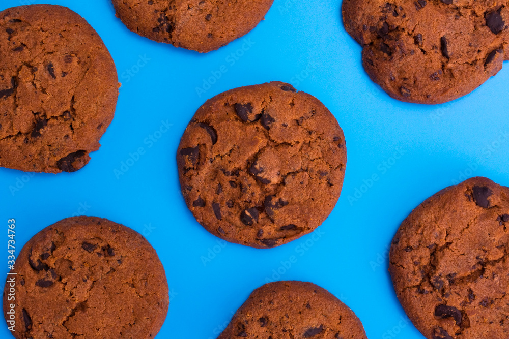 Chocolate cookies on a blue background. Background of homemade chocolate chip cookies.