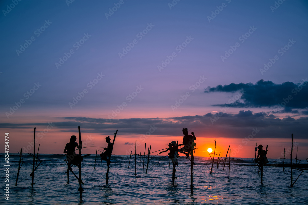 Fototapeta premium Traditional stilt fisherman at sunset in Sri Lanka