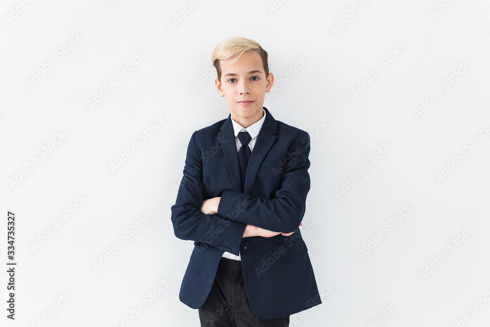 Portrait of stylish school boy teenager in white shirt and jacket against white background. Portrait of stylish school boy teenager in white shirt and jacket against white background.