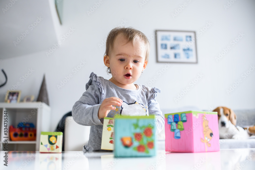 Fototapeta premium Sweet baby playing with educational toys. Baby development