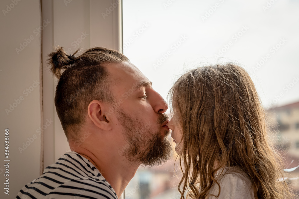 father is kissing her daughter on the nose father is kissing her daughter on the nose