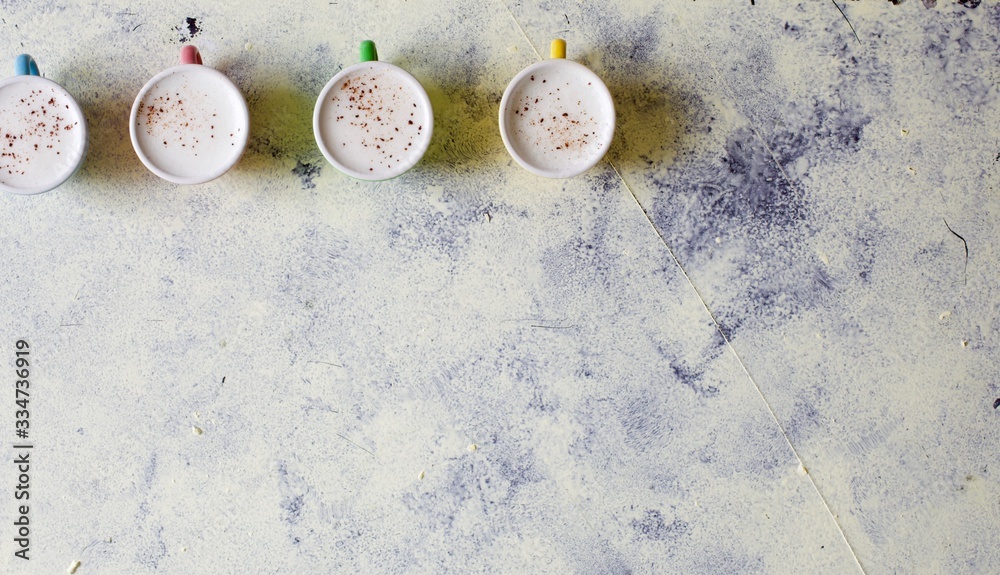 Cute baby cappuccinos or babyccino macchiato flat lay image with copy space Cute baby cappuccinos or babyccino macchiato flat lay image with copy space