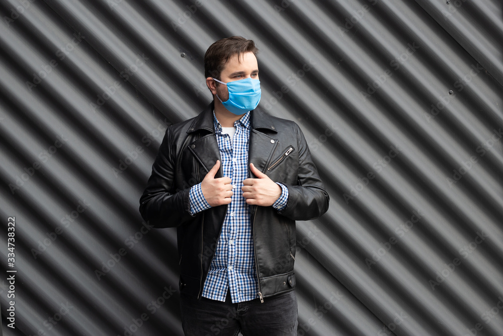 Man in medical mask on the background of black wall Man in medical mask on the background of black wall