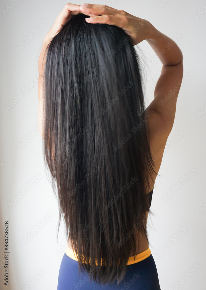 Back view of woman with beautiful long straight black hair. Back view of woman with beautiful long straight black hair.