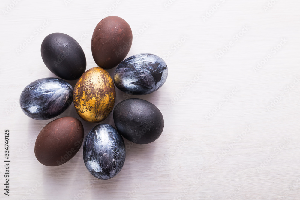 Holidays, traditions and Easter concept - Dark stylish easter eggs on white wooden background with copyspace. Holidays, traditions and Easter concept - Dark stylish easter eggs on white wooden background with copyspace.