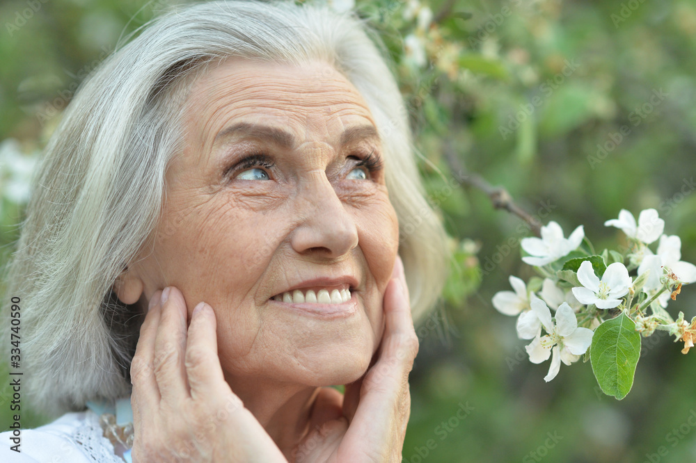 Portrait of happy senior beautiful woman in spring park Portrait of happy senior beautiful woman in spring park