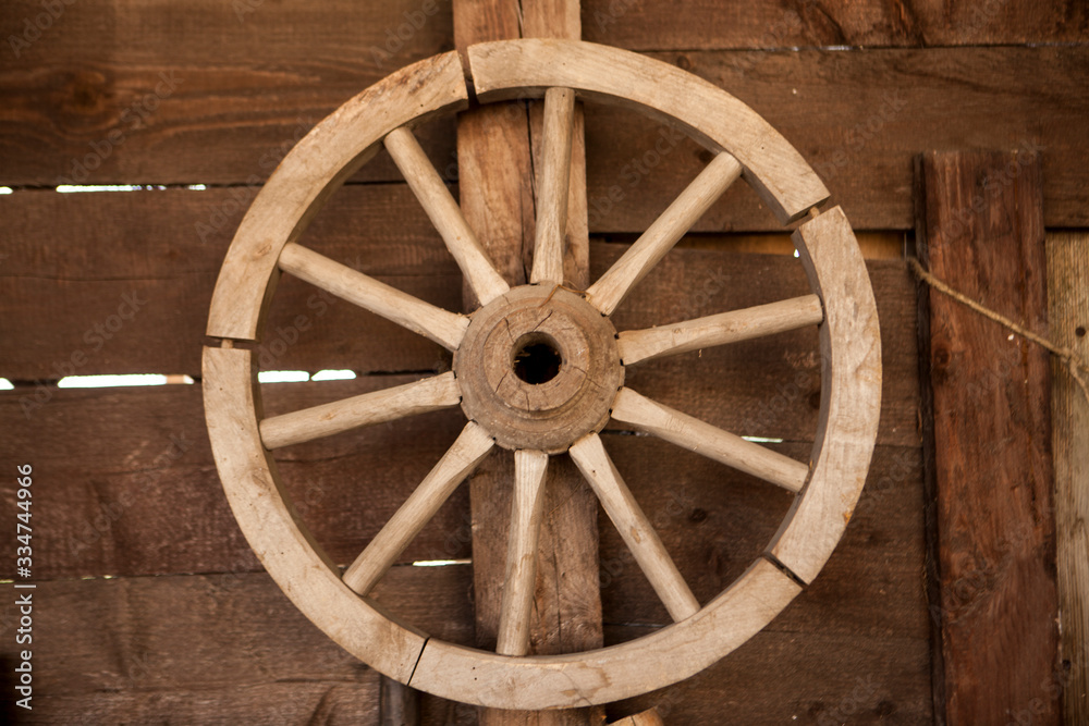 Old wooden cartwheel on a farm