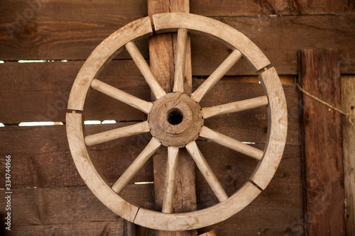 Old wooden cartwheel on a farm © Maria Cherevan