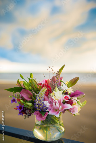 Wedding flower arrangement with lilies in shades of white and pink combined with other flowers