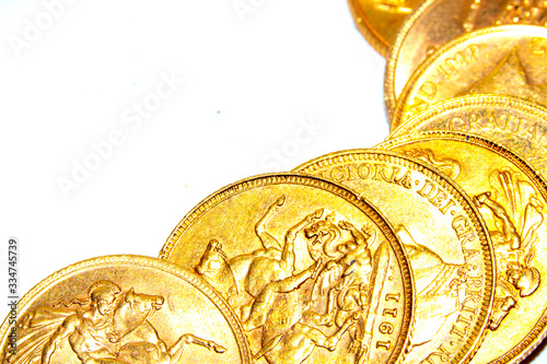 Fotografia A Collection of Gold Sovereign Coins on White Background