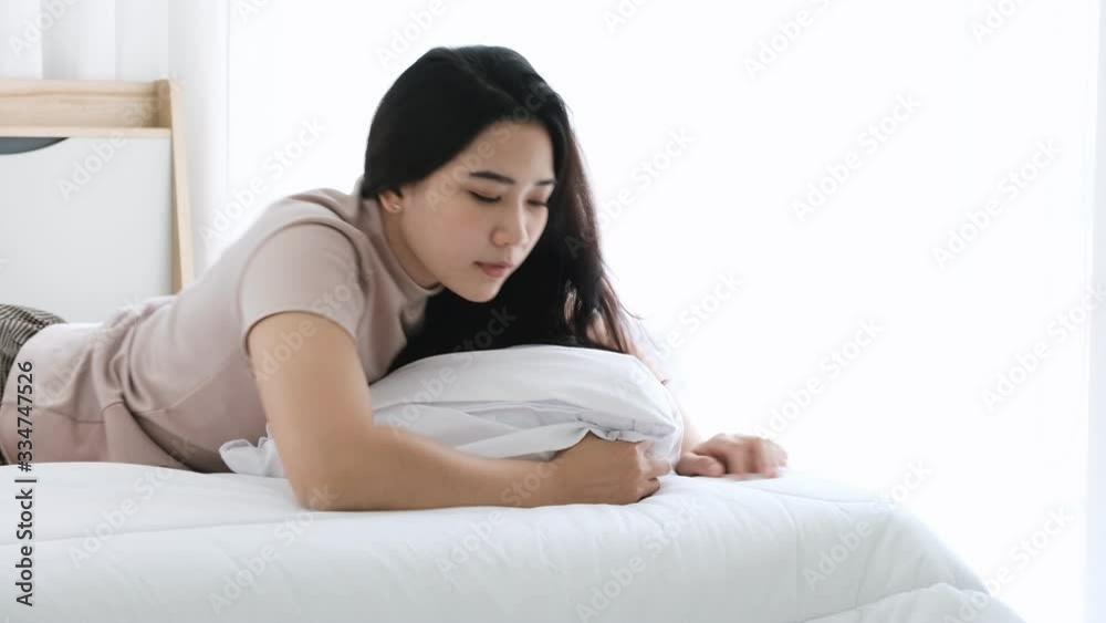 Asian woman sleeping tired and her smartphone from hand slip down to the floor then wake up collect and inspect damage before continue resting. Asian woman sleeping tired and her smartphone from hand slip down to the floor then wake up collect and inspect damage before continue resting.