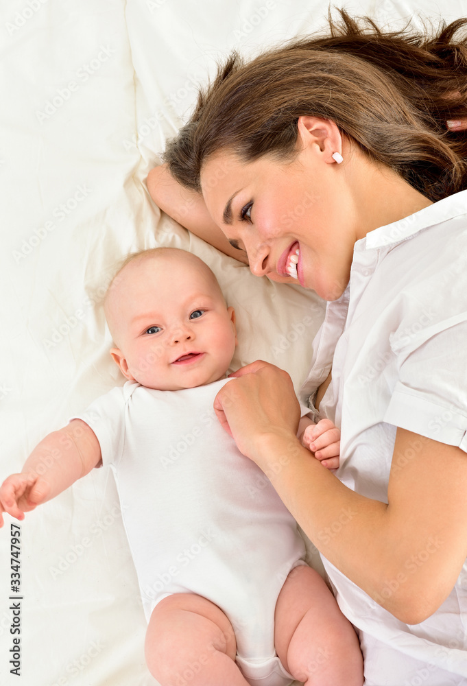 Mother and baby playing and smiling. Happy family. Mother and baby playing and smiling. Happy family.