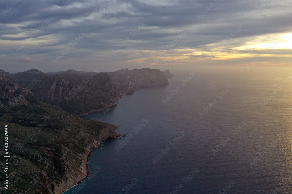 The beautiful island of Mallorca Spain, photography from the air at sunset. Seascape in the evening fog.