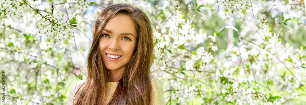 Happy young woman in a flowering spring garden. Spring time. Flowers blossoms. Happy young woman in a flowering spring garden. Spring time. Flowers blossoms.