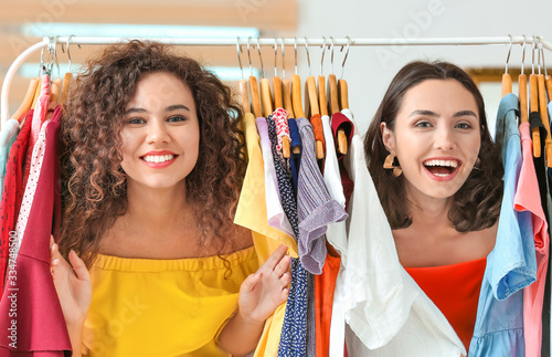 Young women choosing clothe...