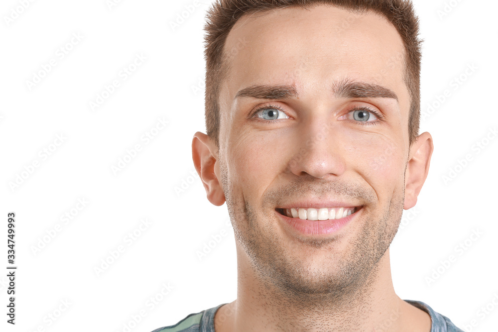 Fototapeta premium Handsome young man with healthy teeth on white background